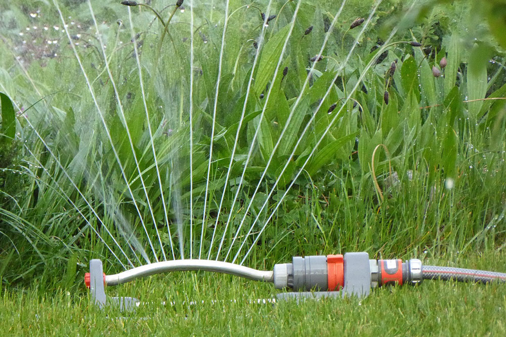 Lawn sprinkler watering grass Lawn sprinkler watering grass