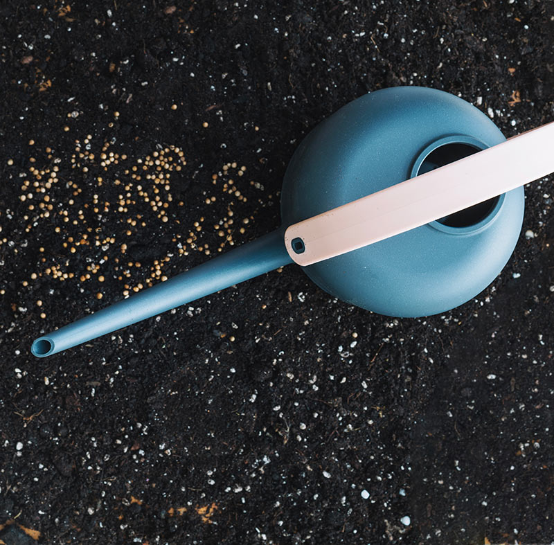 Blue garden soil tool on black gravel Blue garden soil tool on black gravel